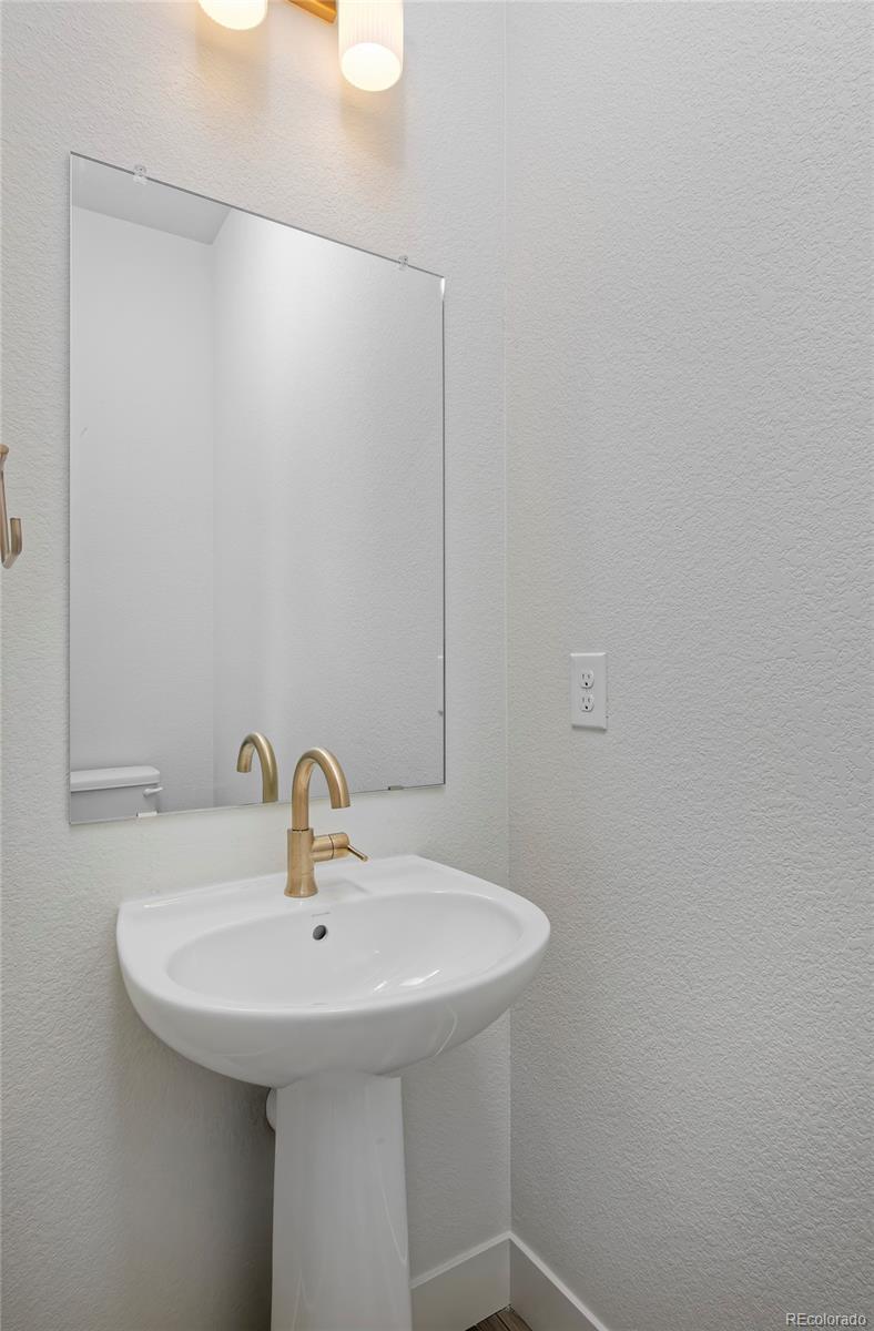 3136 West Bonfils Place Denver, CO 80236 - Photo 22 of 43 a bathroom with a sink and mirror