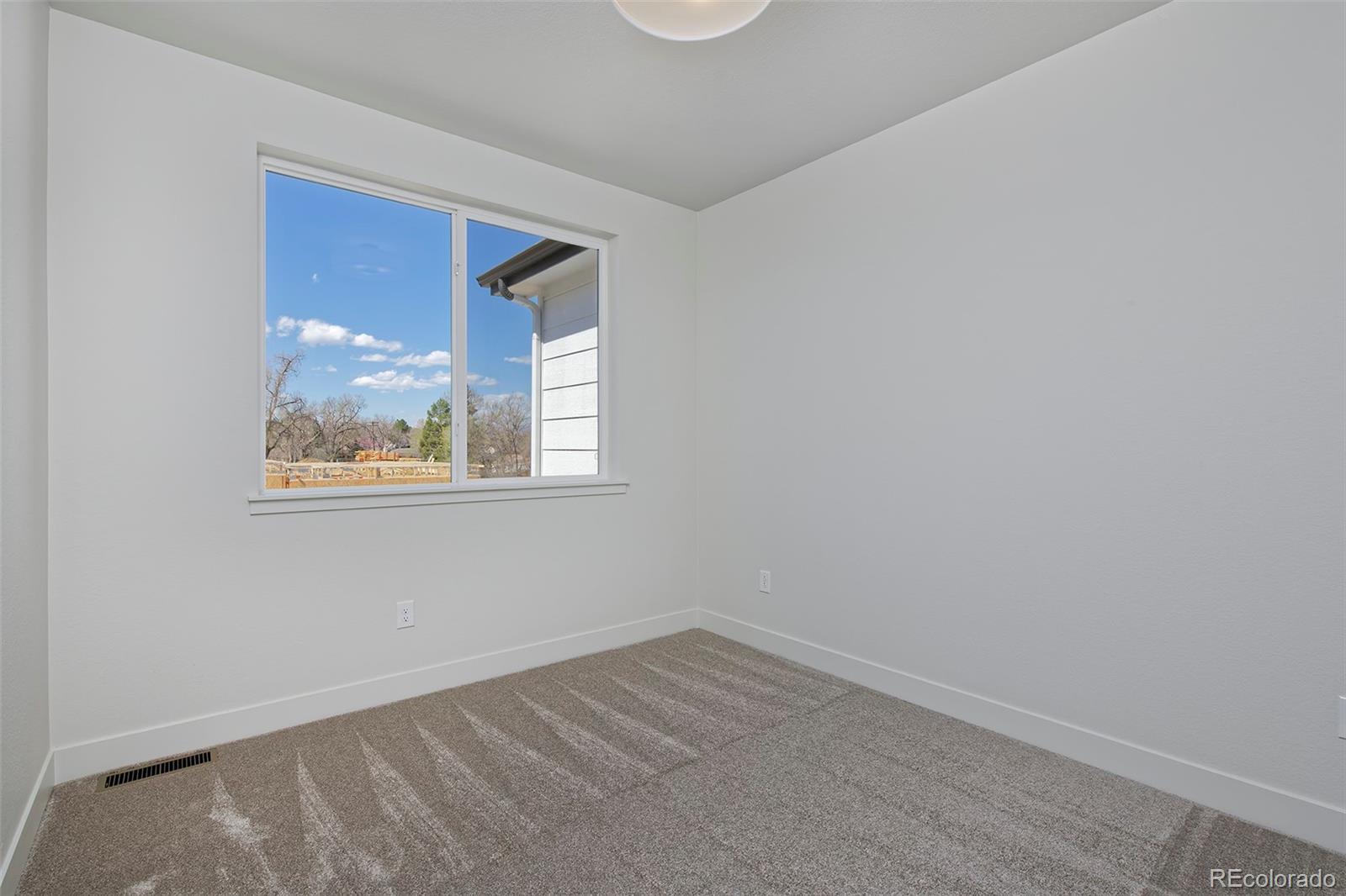 3136 West Bonfils Place Denver, CO 80236 - Photo 26 of 43 an empty room with a window