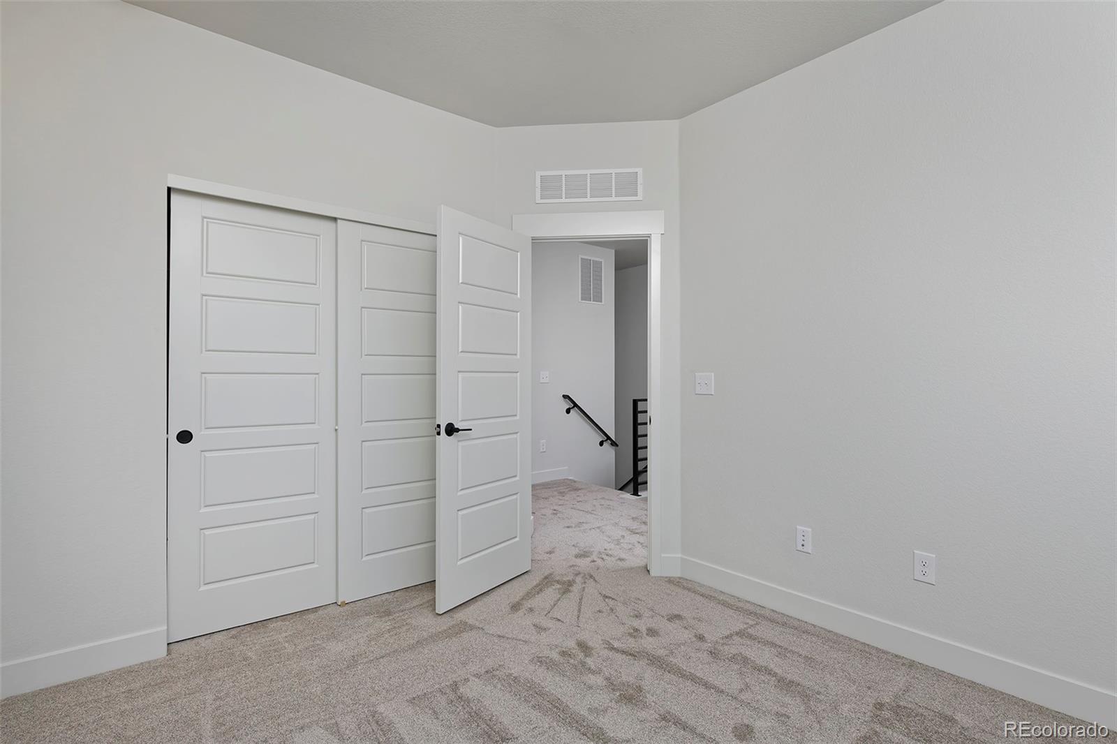 3136 West Bonfils Place Denver, CO 80236 - Photo 27 of 43 wooden floor and closet in a room