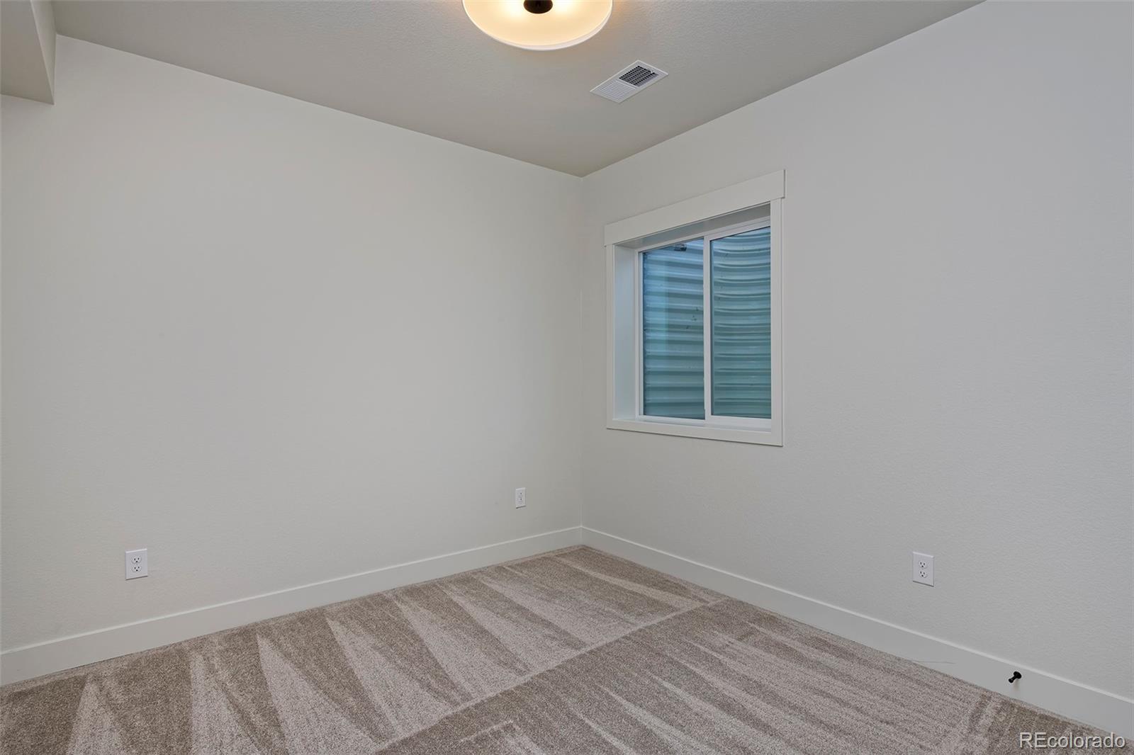 3136 West Bonfils Place Denver, CO 80236 - Photo 39 of 43 an empty room with a window