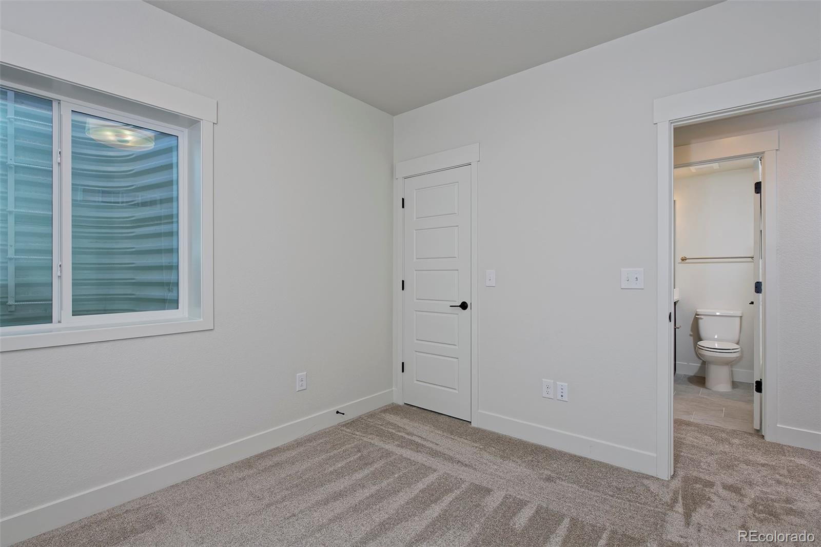 3136 West Bonfils Place Denver, CO 80236 - Photo 40 of 43 a view of room with window and hardwood floor