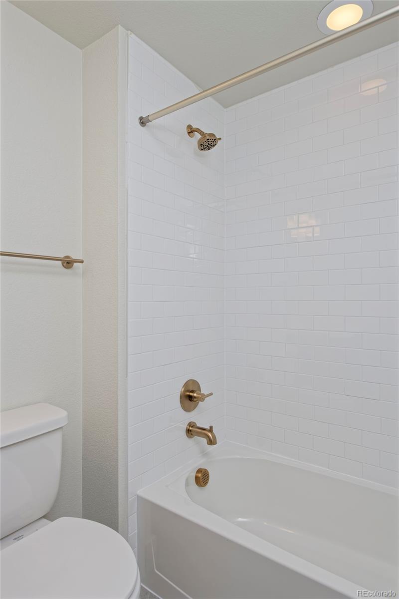 3136 West Bonfils Place Denver, CO 80236 - Photo 42 of 43 a bathroom with a toilet and a bathtub