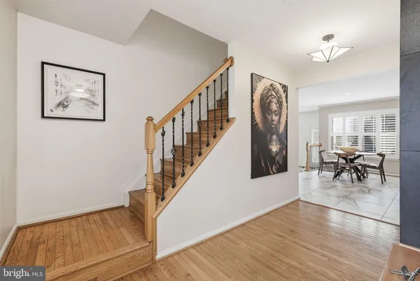 a view of entryway and hall with wooden floor