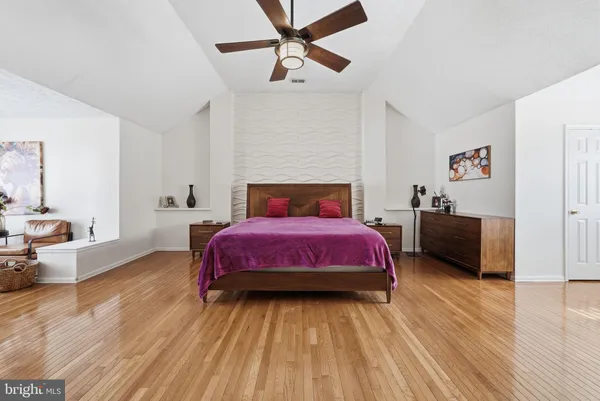 a bedroom with a bed and a couch