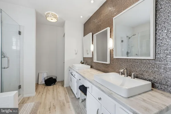 a spacious bathroom with a sink and a mirror
