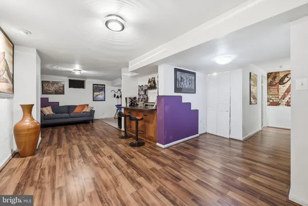 a living room with furniture and a wooden floor