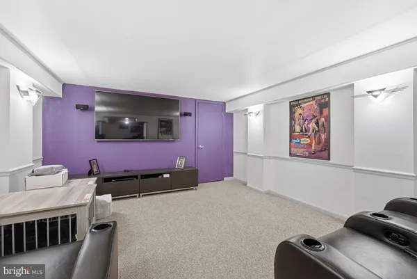 a bedroom with furniture and a flat screen tv
