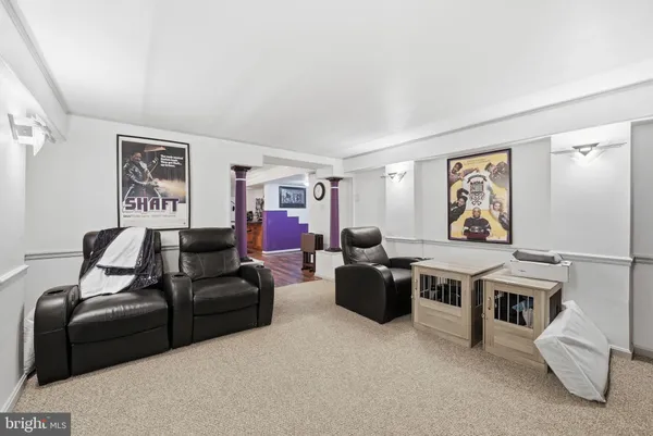 a living room with furniture a couch and wall paintings