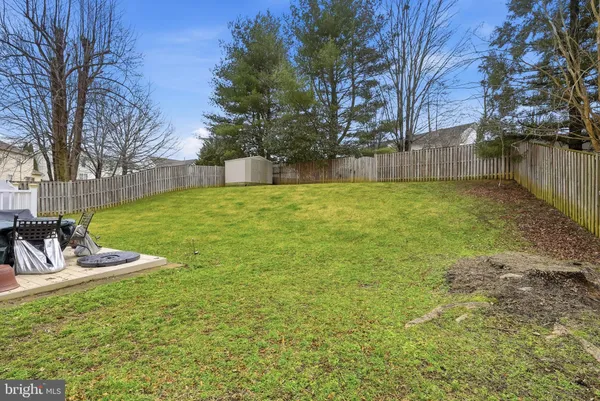 a view of a backyard with wooden fence