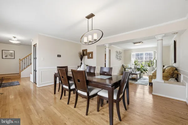 a view of a dining room with furniture wooden floor and chandelier