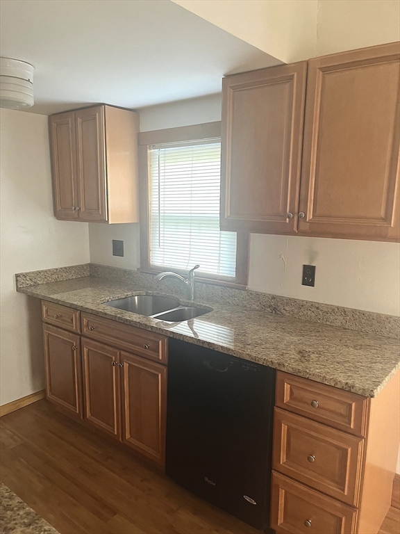 a kitchen with stainless steel appliances granite countertop a sink stove and cabinets