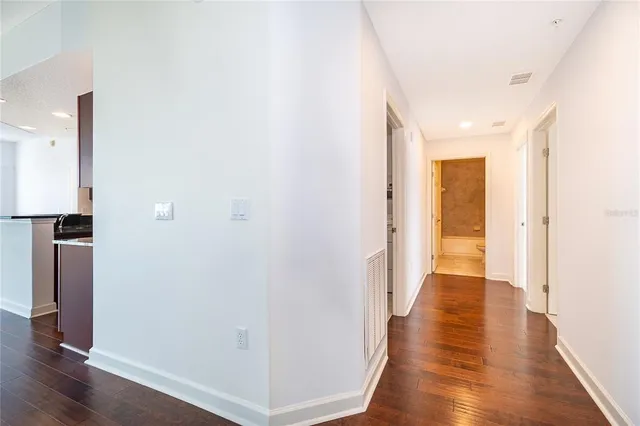 a view of a hallway with wooden floor