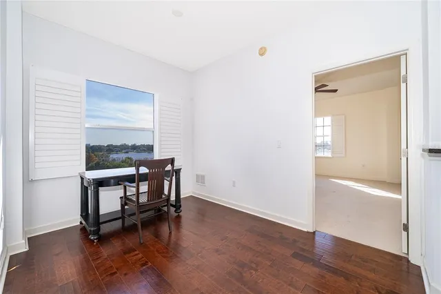 a view of a room with wooden floor pool table and windows