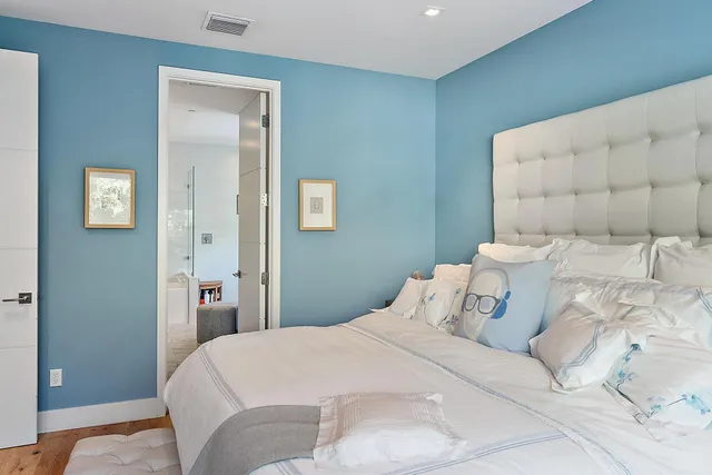 a bedroom with a bed and a mirror