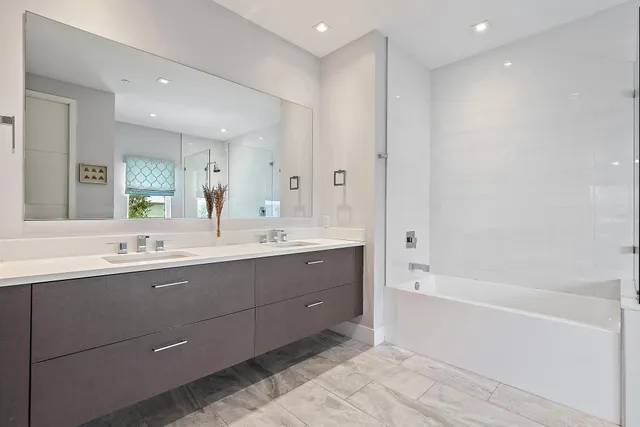 a bathroom with a tub sink and mirror