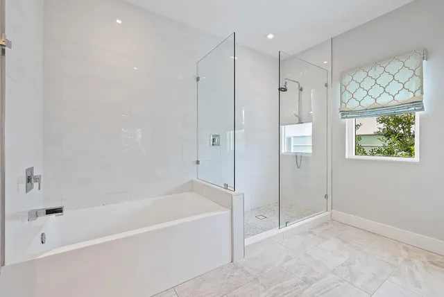 a spacious bathroom with a bathtub and a shower