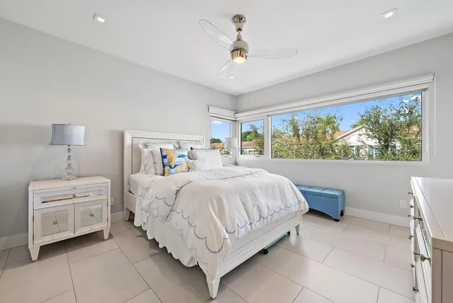 a bedroom with a large bed and a window