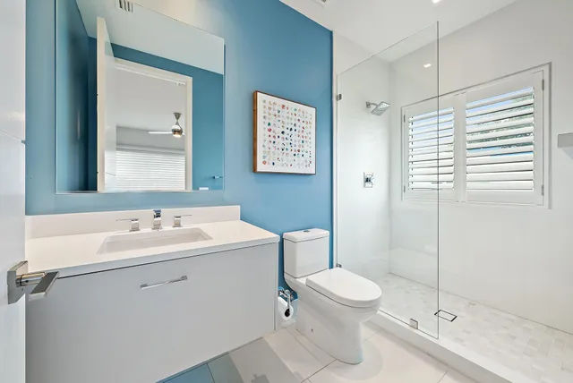a bathroom with a toilet sink and mirror
