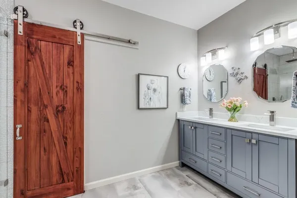 a spacious bathroom with a double vanity sink and a mirror