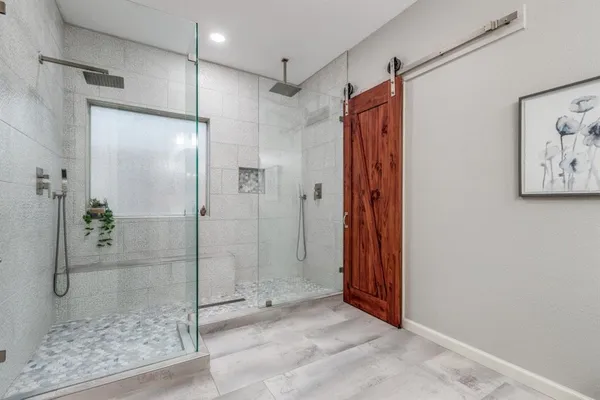 a bathroom with a shower and a glass door