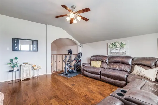 a living room with furniture and a chandelier
