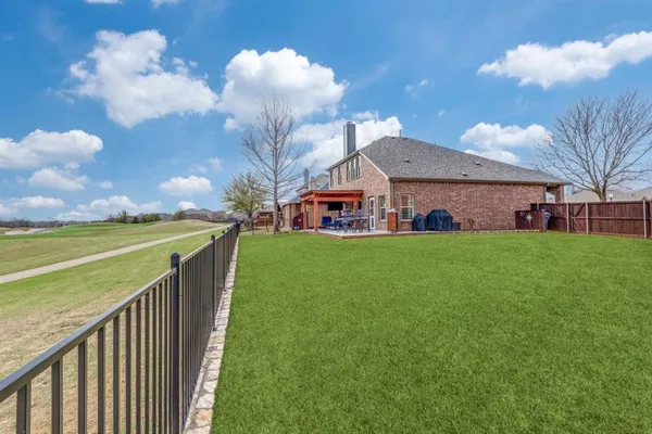 a view of a house with a big yard and large trees