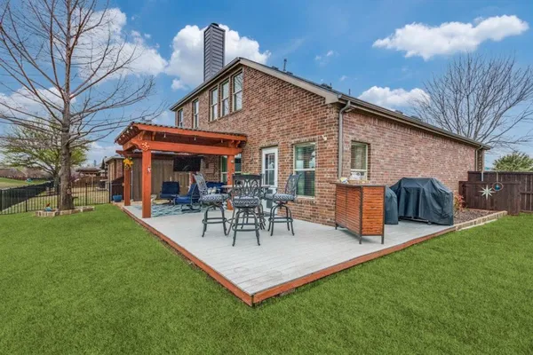 a view of a house with a yard patio and fire pit