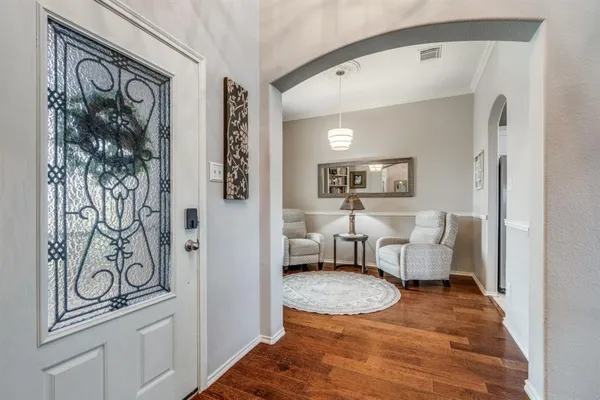 a living room with furniture and a painting on the wall