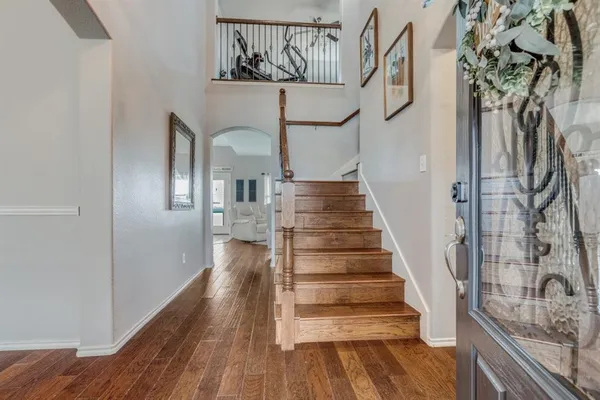 a view of entryway and hall with wooden floor