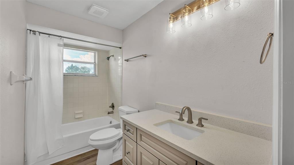 3806 Bent Tree Loop West Lakeland, FL 33813 - Photo 16 of 58 a bathroom with a sink a toilet and shower