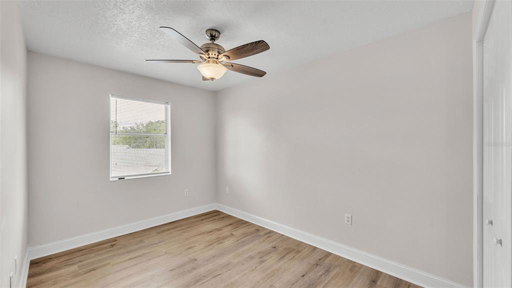 3806 Bent Tree Loop West Lakeland, FL 33813 - Photo 18 of 58 a view of an empty room with wooden floor and a window