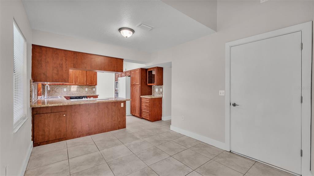 3806 Bent Tree Loop West Lakeland, FL 33813 - Photo 32 of 58 a kitchen with stainless steel appliances granite countertop a refrigerator and a sink