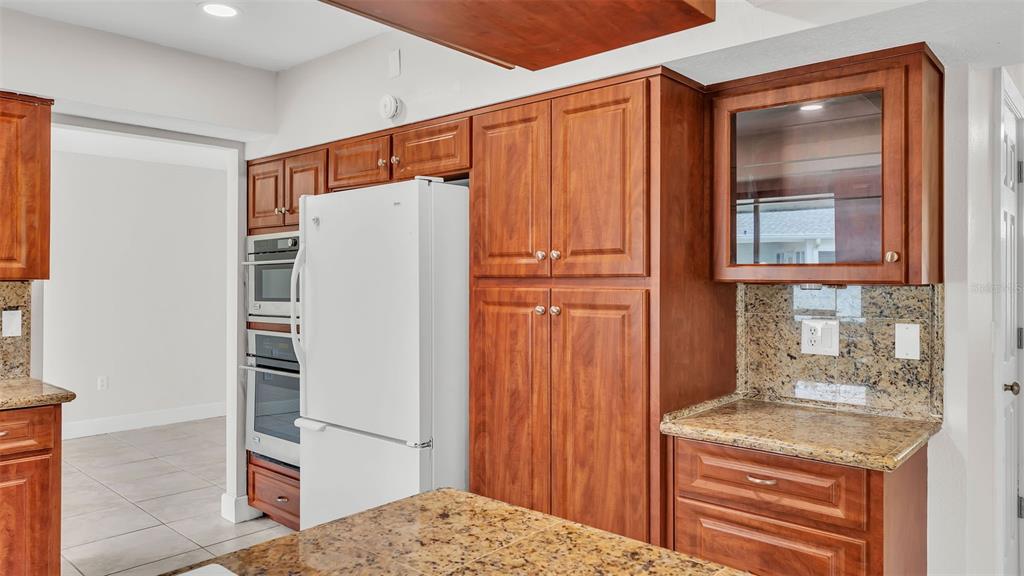 3806 Bent Tree Loop West Lakeland, FL 33813 - Photo 35 of 58 a kitchen with a refrigerator and countertop