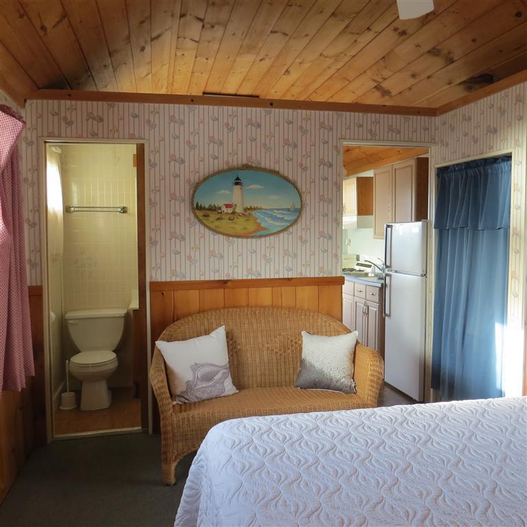 168 Shore Road, Unit 10 Truro, MA 02666 - Photo 7 of 9 a bedroom with a bed and a bathroom
