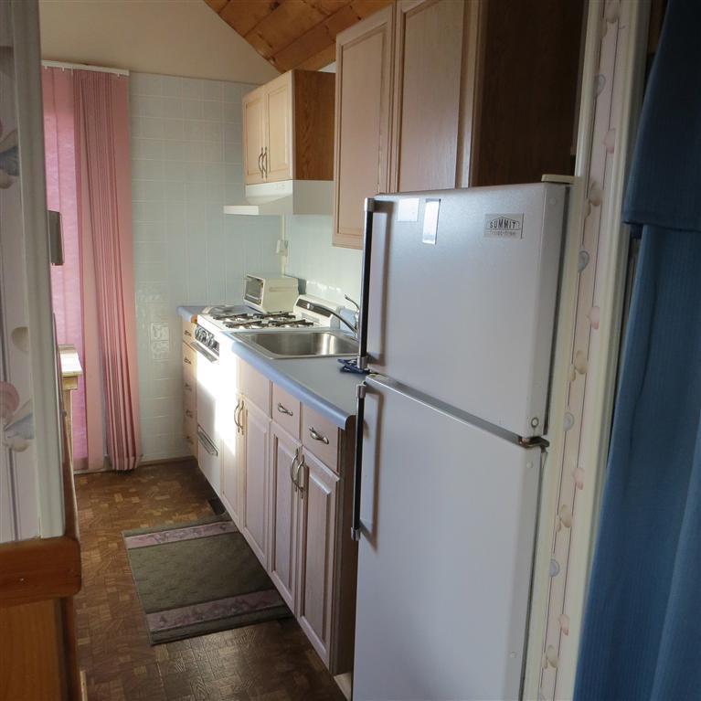168 Shore Road, Unit 10 Truro, MA 02666 - Photo 8 of 9 a kitchen with refrigerator a washer and dryer