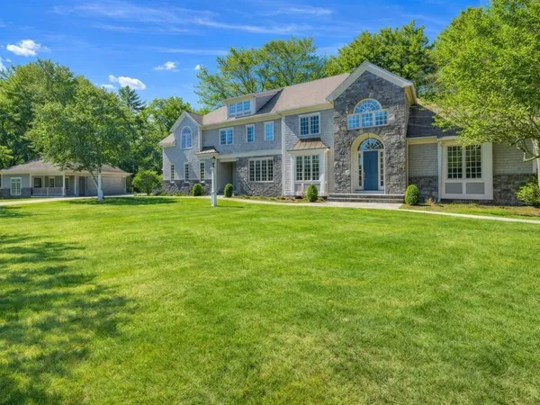 a front view of a house with a garden