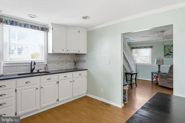 a bedroom with furniture and a large window