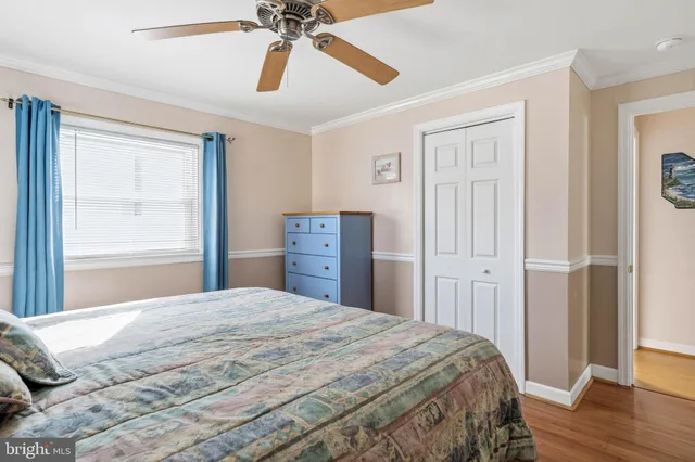 a bedroom with a bed and a ceiling fan