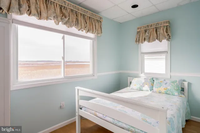 a bedroom with a large bed and a large window