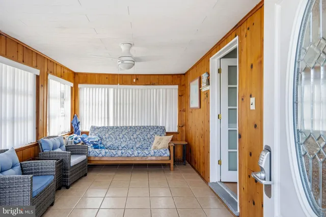 a kitchen with granite countertop a refrigerator a sink and white cabinets