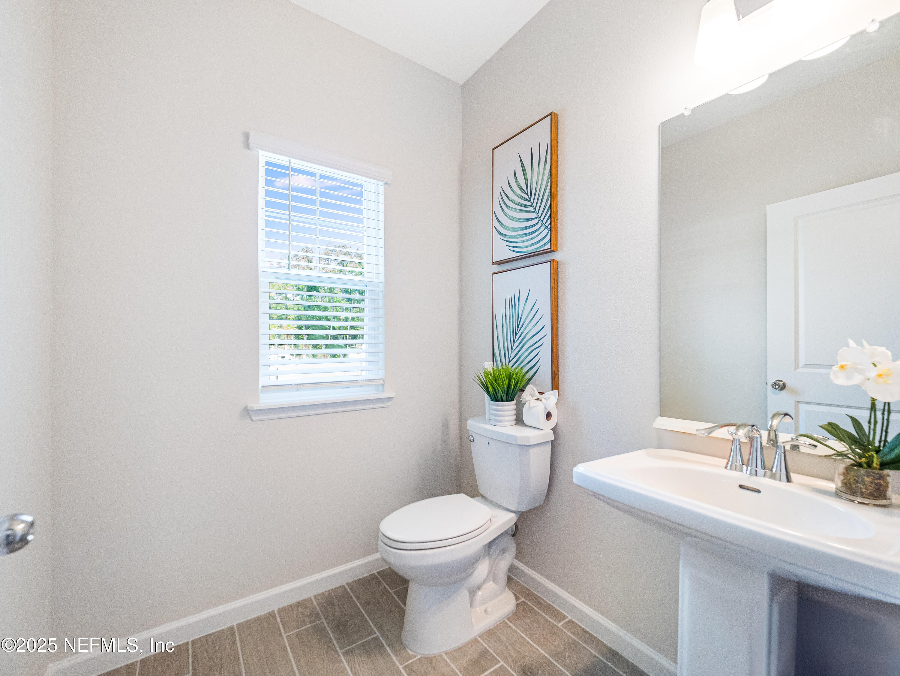 131 Hubbard Bend St. Augustine, FL 32092 - Photo 31 of 42 a bathroom with a toilet a sink and a window