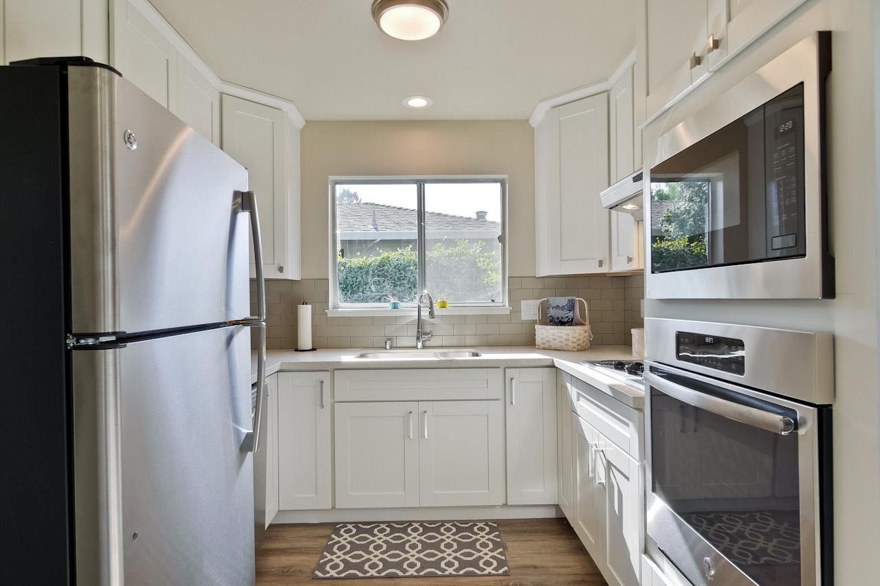 805 Devoto Street Mountain View, CA 94041 - Photo 11 of 26 a kitchen with stainless steel appliances a refrigerator sink and microwave