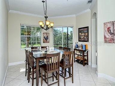 8263 Miramar Way Lakewood Ranch, FL 34202 - Photo 12 of 54 a dining room with furniture a chandelier and window
