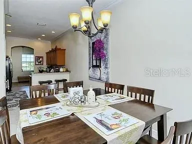 a view of a dining room with furniture and a chandelier