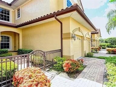 8263 Miramar Way Lakewood Ranch, FL 34202 - Photo 2 of 54 a front view of a house having yard