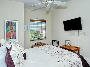 a bedroom with a bed and a flat screen tv