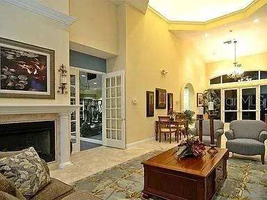 a living room with furniture a fireplace and a large window
