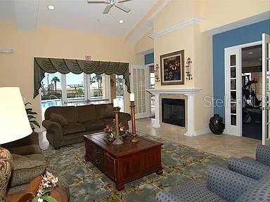8263 Miramar Way Lakewood Ranch, FL 34202 - Photo 40 of 54 a living room with furniture a fireplace and a large window