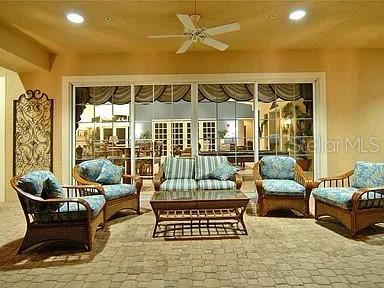8263 Miramar Way Lakewood Ranch, FL 34202 - Photo 47 of 54 a living room with furniture ceiling fan and a window