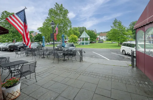 a view of a patio with a table and chairs
